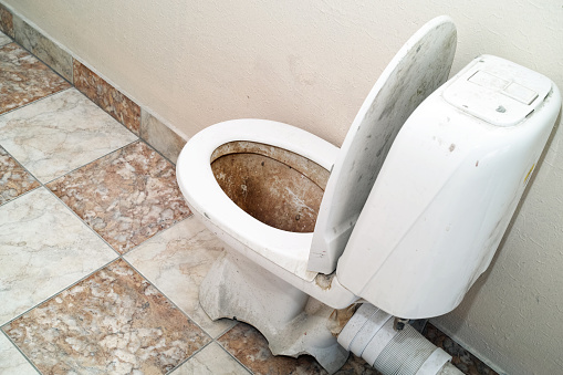 a broken discarded sanitary bowl, indoor shot without people