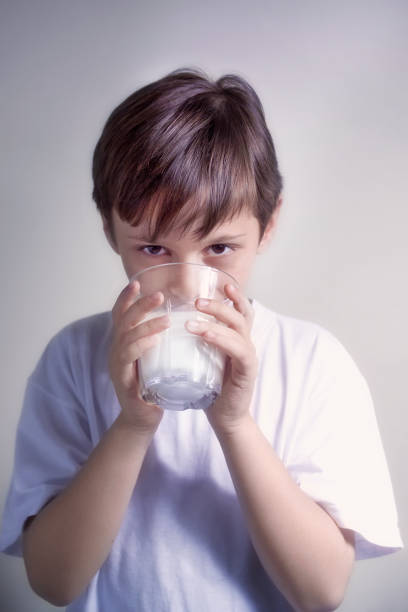 istock Portrait of elementary age boy drinking milk 1344017023