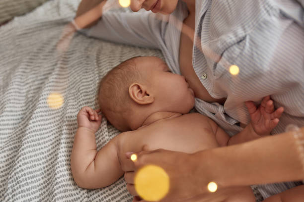 Breastfeeding and bed-sharing to develop perfect bond with child stock photo