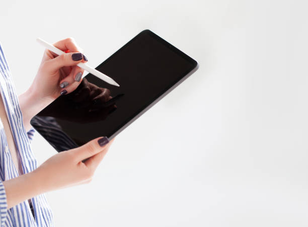 Woman holding iPad pro with white screen on white background. Office background