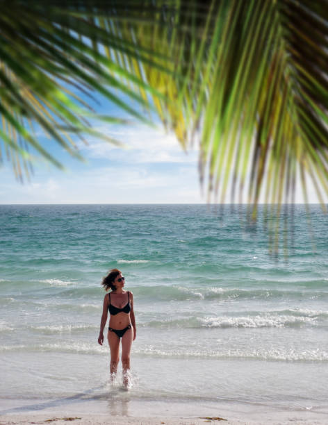 istock Beautiful woman on tropical beach vacation 1344018913