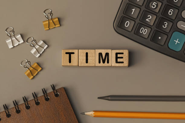 istock Word - time - on small wooden blocks on the desk. Top view 1344019212