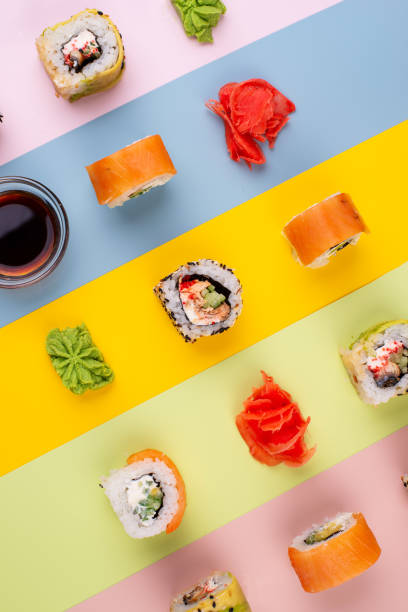 istock Sushi rolls on trendy color background 1344021377