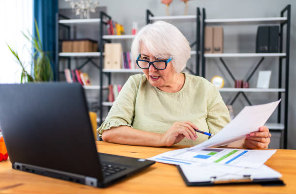 istock Senior woman working from home or using laptop planning or paying bills 1344023145