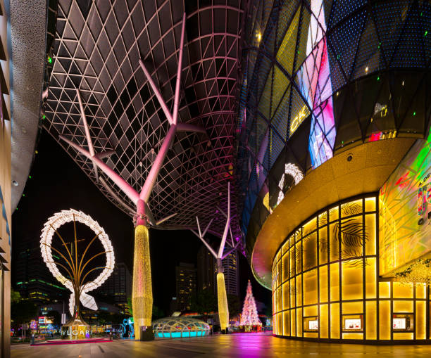 Singapore - 11 Dec 2019: Entrance of Ion Orchard luxury mall during Christmas celebrations, with Bulgari necklace light structure and Cartier jeweller boutique shopfront in Orchard Road commercial district, Singapore