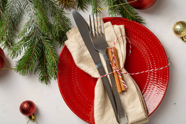 istock Overhead view of red Christmas plate with decor holiday table set 1344026025