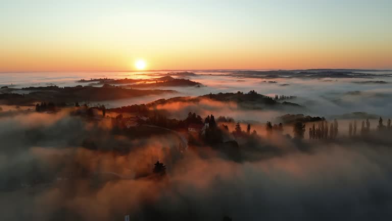 Drone shot of a morning mist floating over the wine-growing region at sunrise. Jeruzalem, Ljutomer. Municipality in Slovenia.
