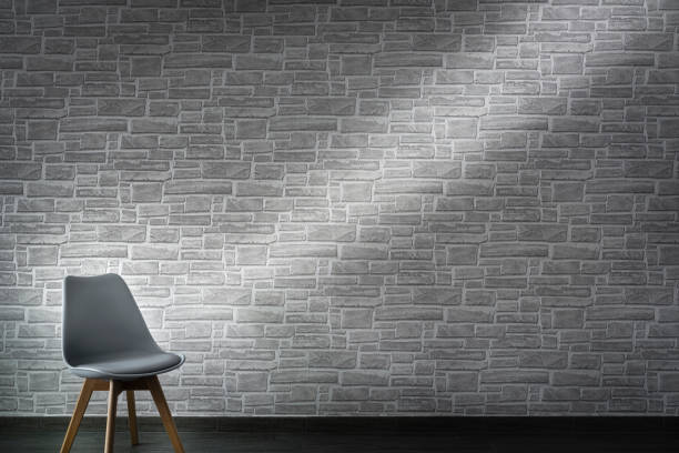 istock Empty chair in front of a gray brick wall 1344027726