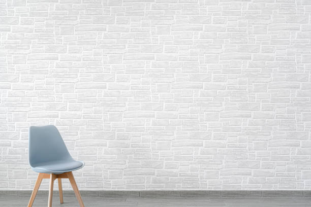istock Empty chair in front of a white brick wall 1344028533