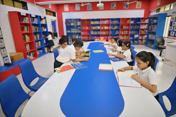 istock School children reading books in a school library 1344030061