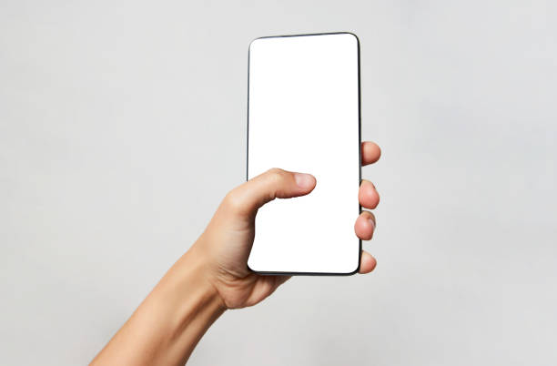 istock Woman hand holding phone on white background with copy space 1344032577