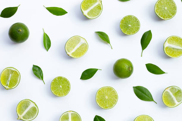 istock Fresh limes with green leaves on white background. 1344034132