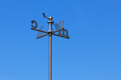 steel vane surmounted by a rooster that indicates the wind direction and cardinal points