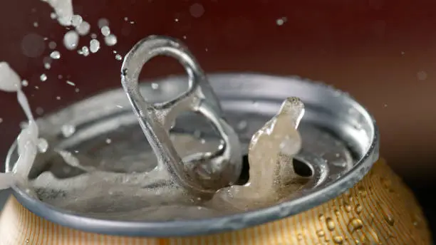 Photo of Freeze motiion of opening a can of beer.