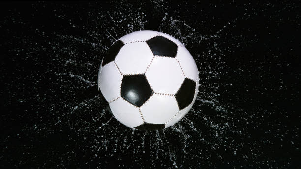 istock Close-up Foot Falling Soccer Ball into Water. 1344034973