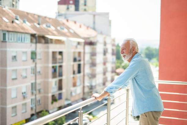 istock Senior man looking at view from his balcony. 1344036250