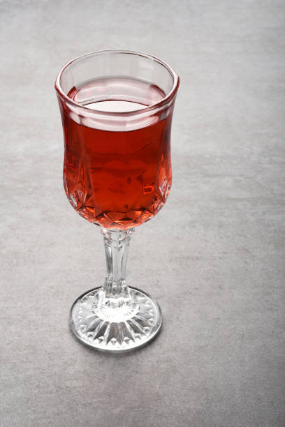 istock Wineglass on the gray stone texture table. Rose wine 1344036472