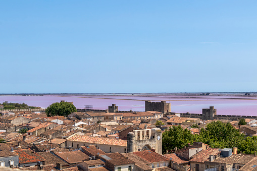 The salt marshes of Aigues-Mortes, southern France, seen from the ramparts of the medieval city old town of Aigues-Mortes and the Etang de la Ville, in petite Camargue, in the Gard, in Occitania