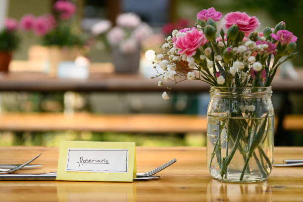istock Hand written table name card and cutlery on a wooden table 1344036524