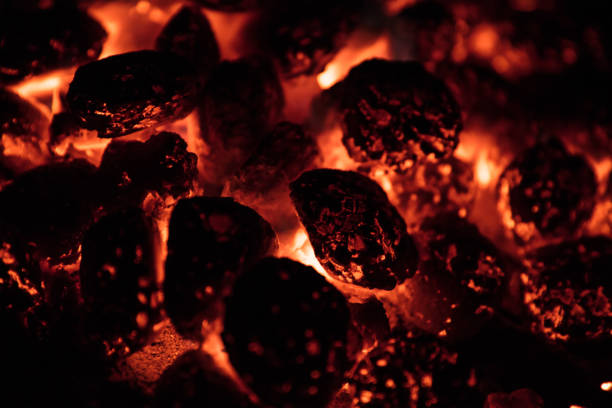 istock Glowing Hot Charcoal Briquettes on garden grill 1344036652