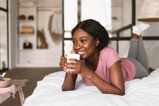 istock Relaxed African American Lady Drinking Coffee Lying In Bed Indoor 1344036729