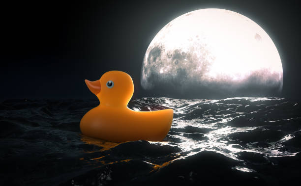 istock Rubber Duck and Moon On Water 1344036824