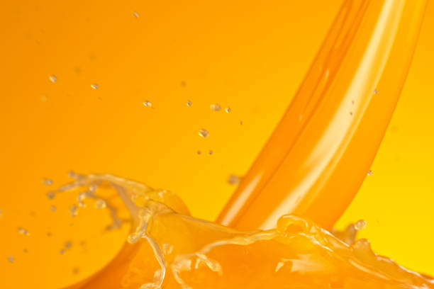 Pouring fresh orange juice splash