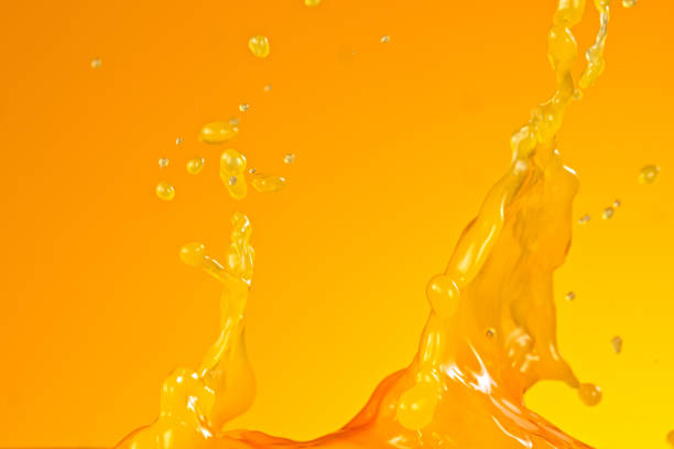 istock Pouring fresh orange juice splash 1344038106
