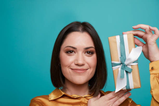 istock A woman showing a birthday  gift box. 1344039553