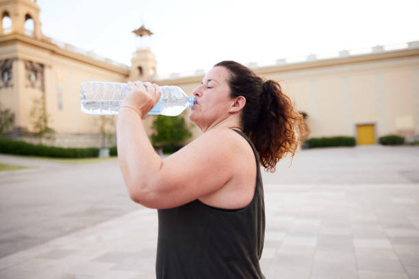 istock A woman drinking water after doing sport from a plastic bottle. 1344040084