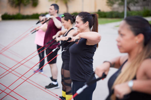 istock Several women and a man doing strength excercise with resitance bands outdoors. 1344040169