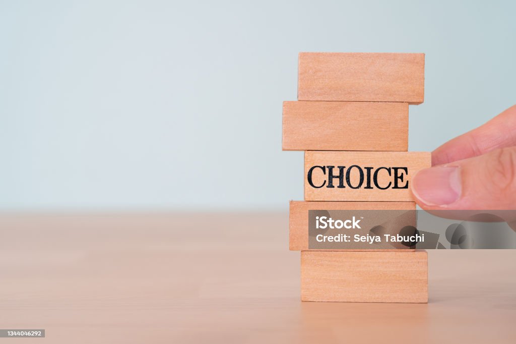 CHOICE; Wooden blocks with "CHOICE" text of concept and a hand. Choice Stock Photo