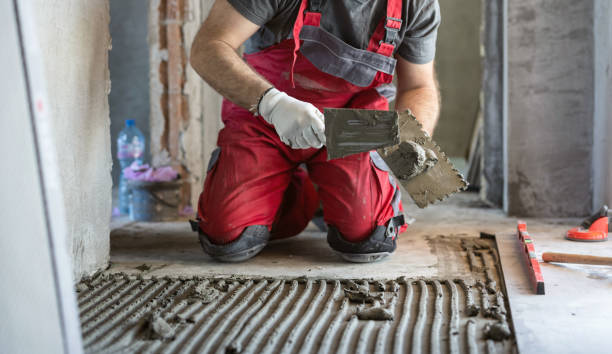 istock Man applying tile adhesive on the floor 1344046499