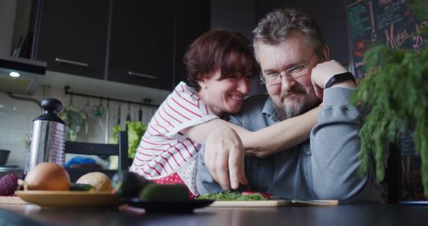 istock Mature couple is preparing food together 1344046525