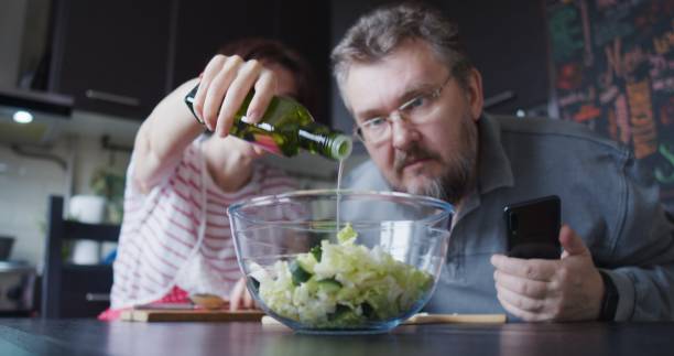 istock Mature couple is preparing food together 1344046623