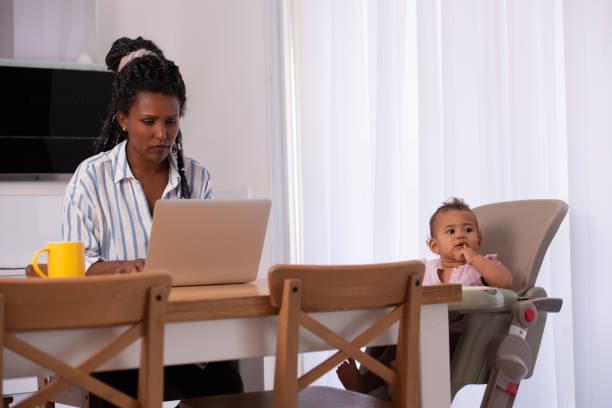 istock A mother working from home while sitting with her baby child. 1344056553
