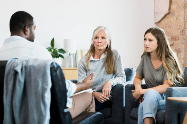 istock Therapist gestures while advising serious mother and daughter 1344060069