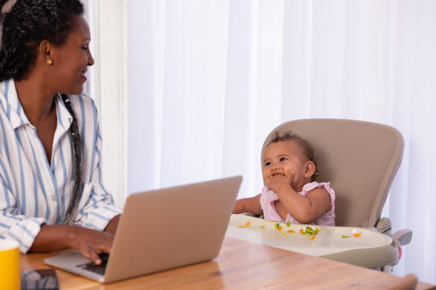 istock A mother working from home while sitting with her baby child. 1344060081