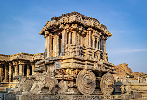 istock Richly sculpted stone chariot with clear blue sky background at Hampi, Karnataka. It is considered to be the most stunning architecture of the Vijayanagara kingdom. 1344073578