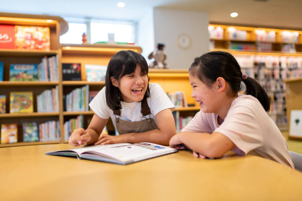 Friends relaxing together in the library Friends relaxing together in the library. Okayama, Japan. child japanese culture japan asian ethnicity stock pictures, royalty-free photos & images