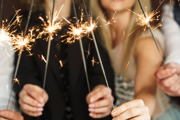 istock Party people with bruning sparklers celebrating  holiday or event 1344079559