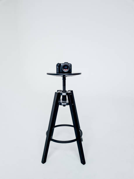 Gray background black chair with a camera