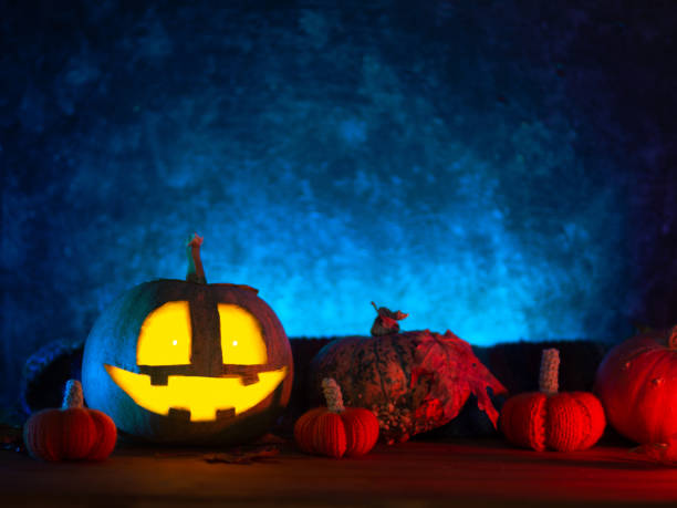 istock halloween pumpkin with a smiling face. Blue background, neon style, copy space 1344081638