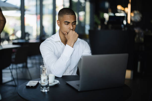 istock Young businessman uses laptop to work at the cafe 1344081749