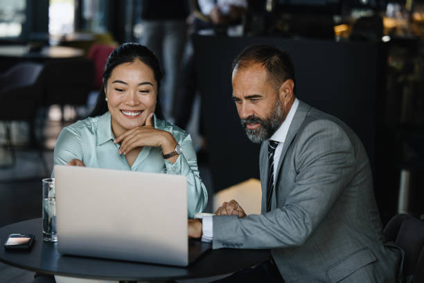 istock Two business people having a meeting in a coffee shop, discussing work 1344081928