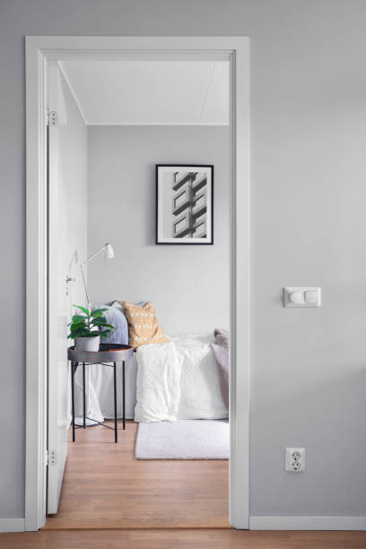 View into a modern guest room through a doorway View through a doorway into a modern room with a bed, a guest room. doorway stock pictures, royalty-free photos & images