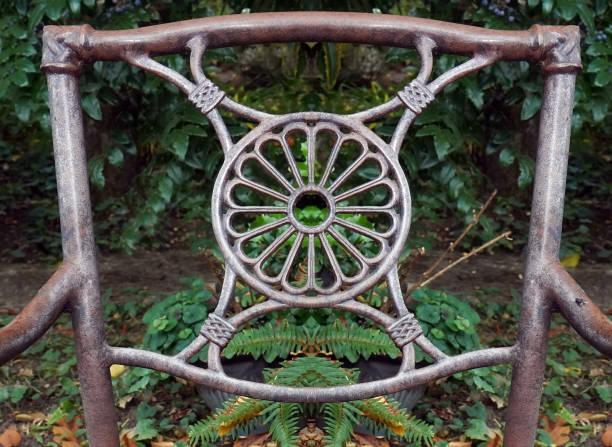 Detail back of rusty garden chair with geometric pattern.