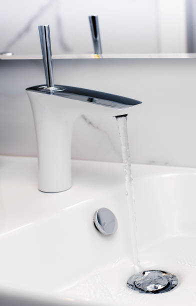 istock Open tap spilling water into the sink 1344083925