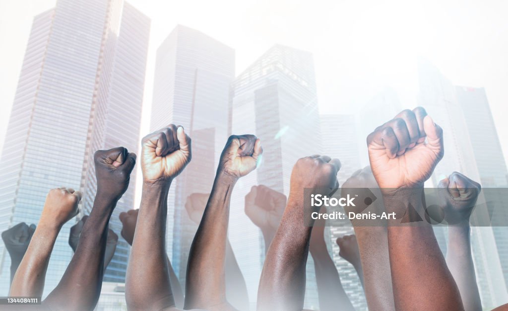 Raised hands of african american men clenched into fists on light background. Stop racism concept Protest Stock Photo