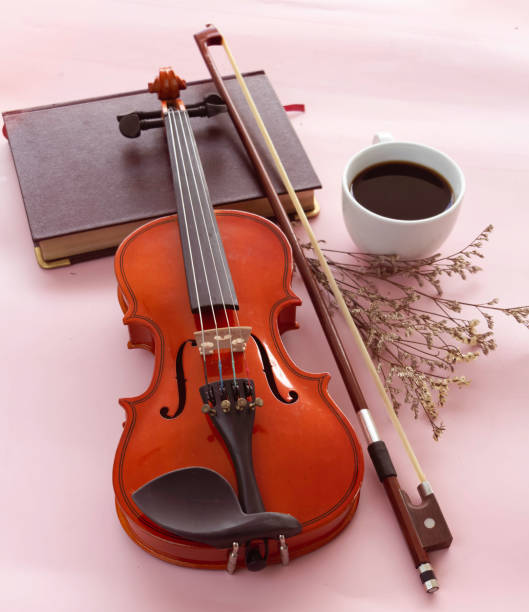 istock Violin and bow put beside White ceramic cup with black coffee, 1344084659